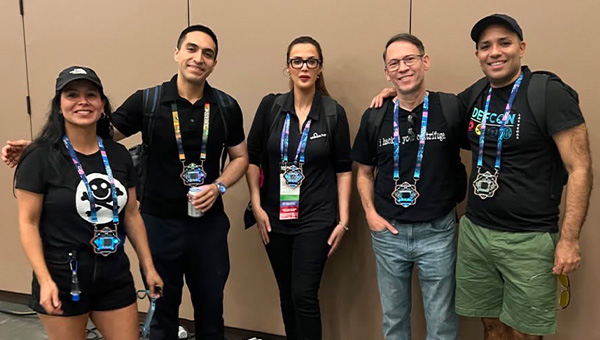 Khadija Taki (center) and others attend the Def Con conference.
